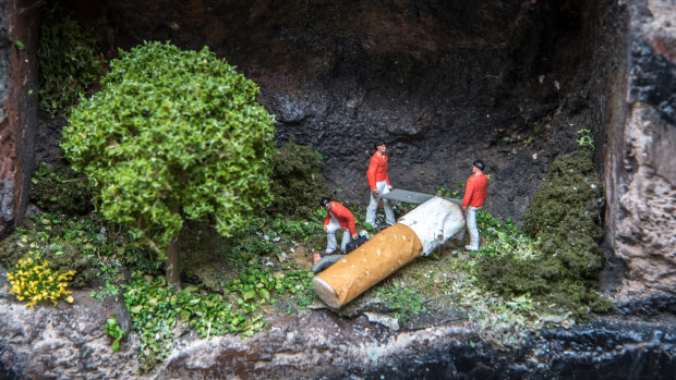 A tiny man is crushed by a cigarette in one of the installations by Ms Sonntag.