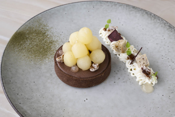Cocoa tart with poached pear balls, lemon myrtle, Chantilly cream and oabika gel.