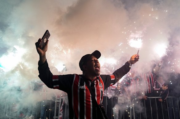 A Sao Paulo fan cheers as the team bus arrives ahead of a Copa do Brasil soccer match against Atletico Mineiro, at the Morumbis Stadium in São Paulo, Brazil.