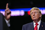Donald Trump listens as gubernatorial candidate Vivek Ramaswamy speaks at a campaign rally earlier this month.