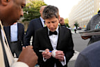 OpenAI CEO Sam Altman signs items as he walks to the White House to attend a state dinner hosted for China’s President Xi Jinping, Thursday, Sept. 24, 2026, in Washington. (AP Photo/Carolyn Kaster)