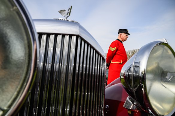 Chelsea Pensioner Brian Rolfe walks past a 1949 Bentley MkVI Special “Mallalieu”, as he browses some of the classic cars on display on the press day of the Salon Privé motoring event at Royal Hospital Chelsea in London, England.