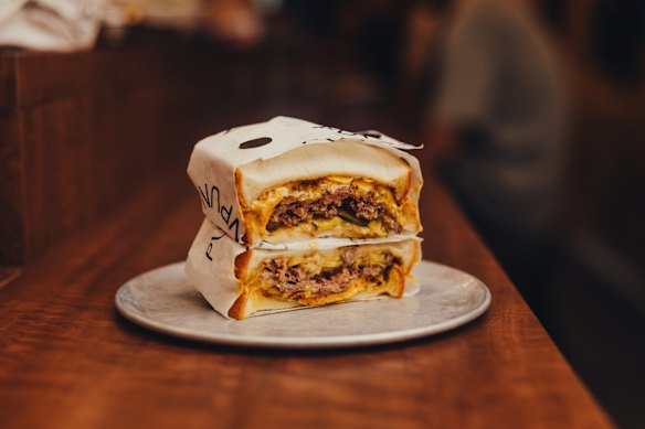 Beef smash patty sandwich with pickles and Tokyo mac sauce.