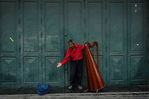 A harp player bows after playing a song in downtown Lima, Peru.