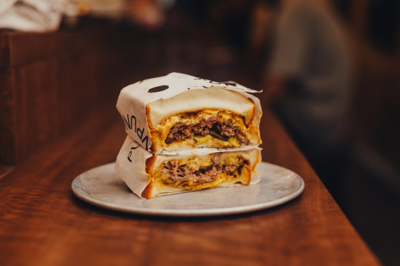 Beef smash patty sandwich with pickles and Tokyo mac sauce.