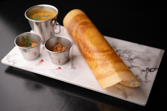 Masala dosa, a savoury crepe rolled around a soft, savoury potato filling.