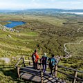 Hikers on Cuilcagh Boardwalk, in Ireland’s Hidden Heartlands, a destination for those who prefer unhurried journeys.