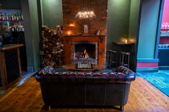 The fireplace-facing Chesterfield lounge at Ambergris.