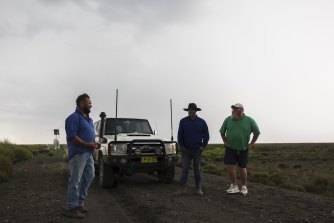 Nari Nari Tribal Council members and land managers Mark Schneider and Jamie Woods stand with Rene Woods as they watch a severe storm roll in over Gayini. 