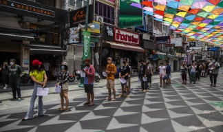 People line up for COVID-19 tests this week on Khaosan Road in Bangkok. 