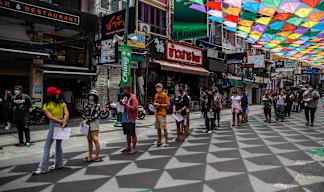 People line up for COVID-19 tests this week on Khaosan Road in Bangkok. 