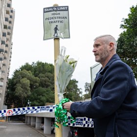 Local Murray Gilett leaves flowers at the Waterloo unit block.