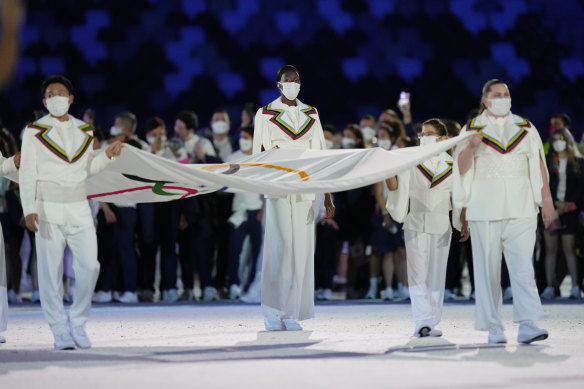 Australian Elena Galiabovitch (right) carries the Olympic flag into the stadium. 