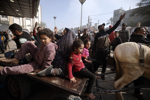 Palestinians wounded during the Israeli bombardment of the Gaza Strip are brought over a donkey cart to the Nasser hospital in Khan Younis.