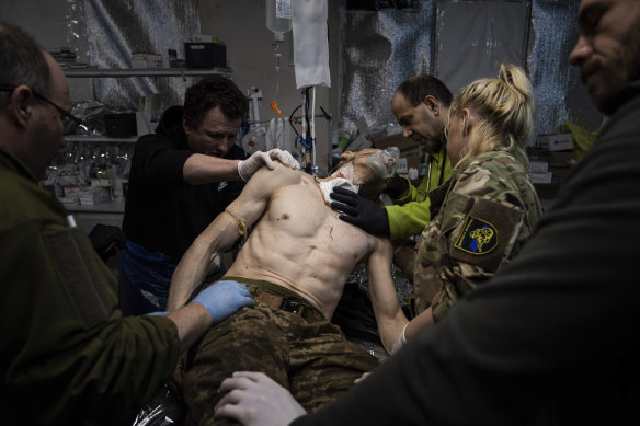 A fight for liberal values: Ukrainian military medics treat their wounded comrade at the field hospital near Bakhmut, Ukraine last month.