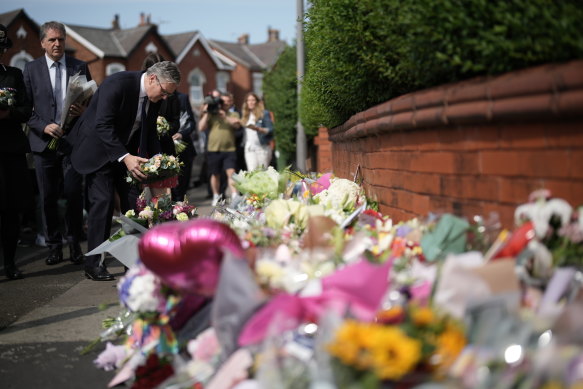 British Prime Minister Sir Keir Starmer leaves a floral tribute to the victims of the Southport knife attack.