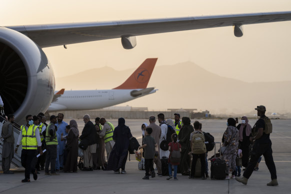 Passengers board a Qatar Airways plane at Kabul airport on Thursday.