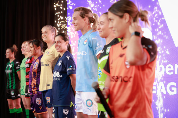 Players face the crowd at the A-League Womens launch in November 2022. Laura Hughes from Canberra United is pictured next to Katrina Gorry (far right) from Brisbane Roar.