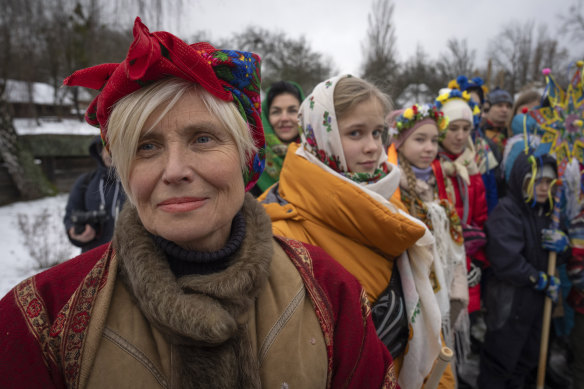 People dressed in national costume celebrate Christmas in the village of Pirogovo outside capital Kyiv, Ukraine.