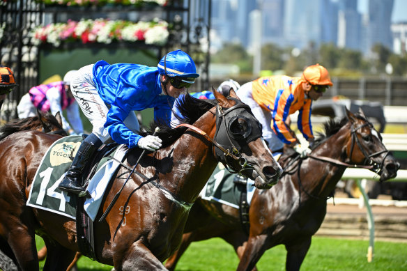 Jamie Kah, aboard Cylinder, claims the Newmarket Handicap at Flemington.