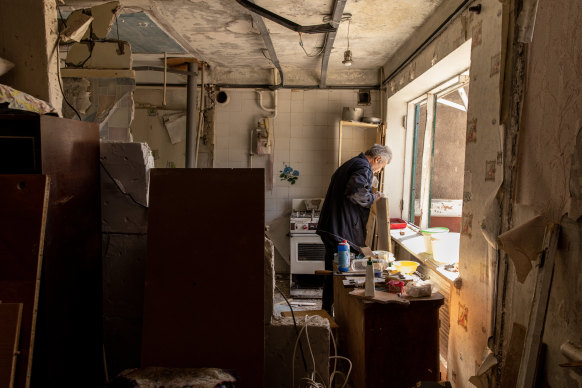 A man works to clean debris from an apartment that was damaged one day before when a Russian missile struck outside the residential building in Kramatorsk, Ukraine. 