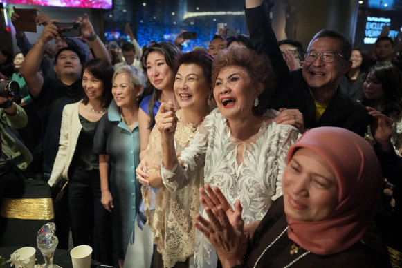 Michelle Yeoh’s mother Janet (second from right) celebrates after her daughter wins best actress.