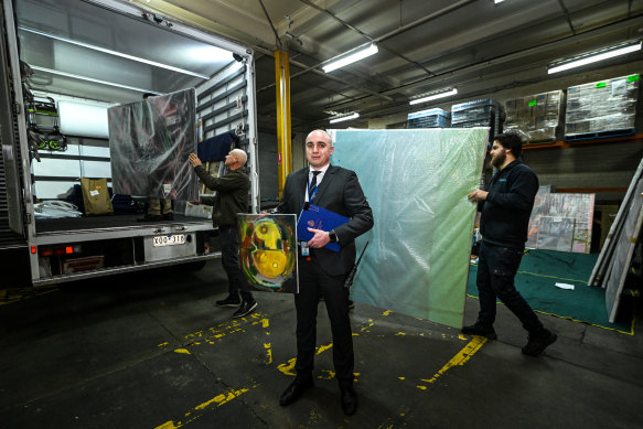 Senior Constable Aidan Blake prepares to release missing artworks seized from a storage facility after a tip-off.