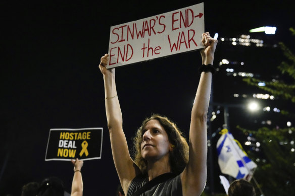 A demonstrator in Tel Aviv demands a ceasefire in Gaza after the news emerged that Yahya Sinwar was killed.