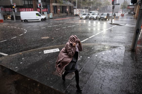 A pedestrian runs through heavy rainfall in Sydney’s CBD in May.