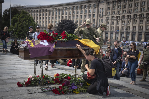 People pay their last respects at a coffin of military medic Dariya Filipova during a farewell ceremony in Independence Square in Kyiv this month.