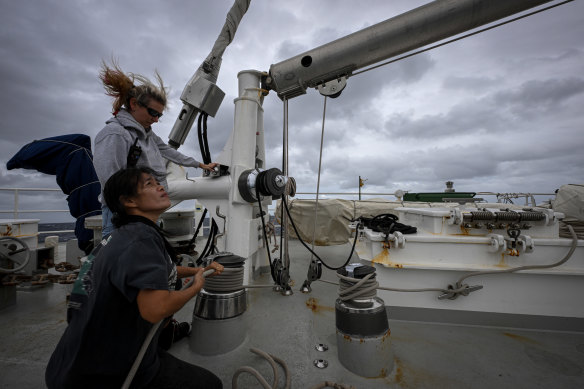 Second mate Katharina Koenig and deck hand Tim Atichakaro raise the the Rainbow Warrior’s sails.