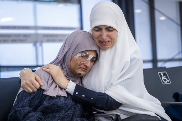 Ranem Abu-Izneid is embraced by her mother, Rana, at Melbourne Airport on Sunday.