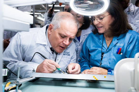 The Prime Minister tries his hand at some soldering on Friday morning.