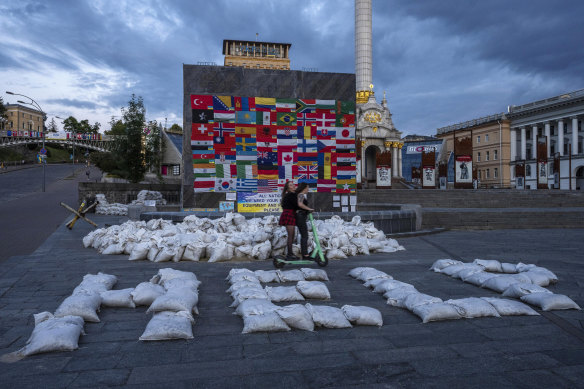 Flags are displayed from around the world and sandbags spell out “HELP” in Kyiv’s Maidan Square on June 25.
