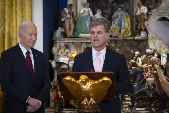 Tim Shriver speaks at a dinner to celebrate the Special Olympics in the  White House on Tuesday as President Joe Biden looks on.