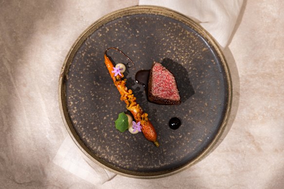 A dish of wagyu beef with cognac carrot, Jerusalem artichoke and black garlic.