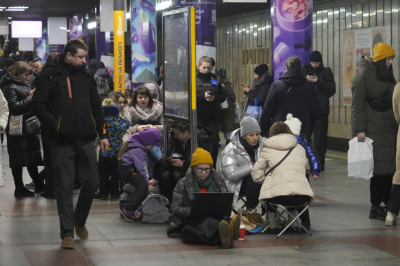 People gather in a subway station being used as a bomb shelter during a rocket attack in Kyiv on Thursday.