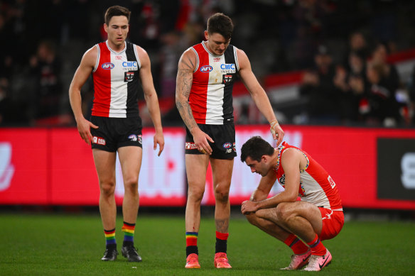 Double trouble: Josh Battle consoles Sydney’s Logan McDonald after St Kilda’s upset win.