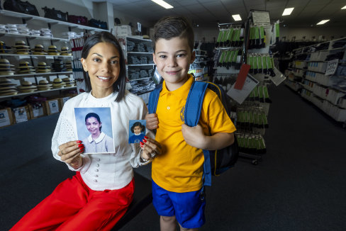 Monica Tratt holding photos of herself as a child in Korowa Anglican Girls’ School and Kew East Primary School uniforms bought at Bob Stewart stores, pictured with her son Lachlan, 6.