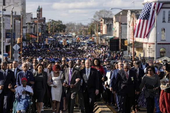 Vice President Kamala Harris and many others walk across the Edmund Pettus Bridge commemorating the 59th anniversary of the Bloody Sunday voting rights march in 1965, in Selma, Alabama.