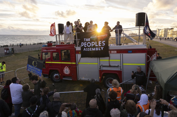 Former Labour leader Jeremy Corbyn speaks from the top of a fire engine parked outside the conference. 