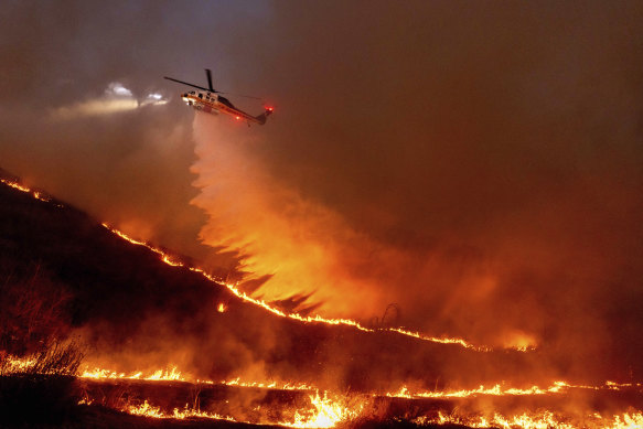Water is dropped by helicopter on the Kenneth fire in the West Hills of Los Angeles.