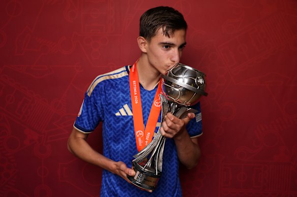 Gianluca Okon kisses the trophy he won with Italy at the U17 Euros last weekend.