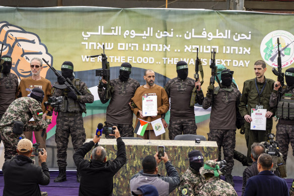 Israeli captives (from left) Ohad Ben Ami, Eli Sharabi and Or Levy flanked by Hamas fighters before being handed over to the Red Cross in Gaza on Saturday.