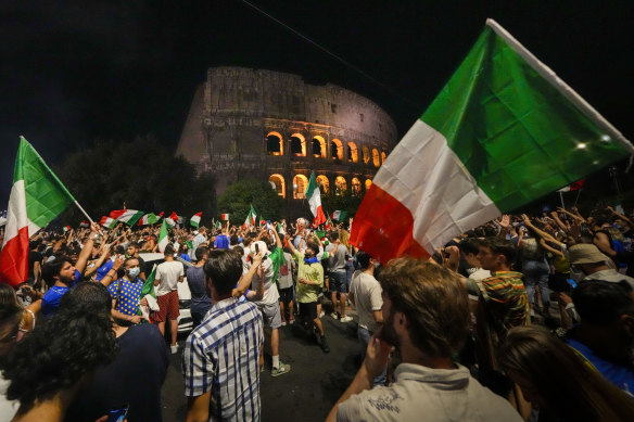 Fans celebrate at the Colosseum in Rome after Italy’s penalty shootout win over England.