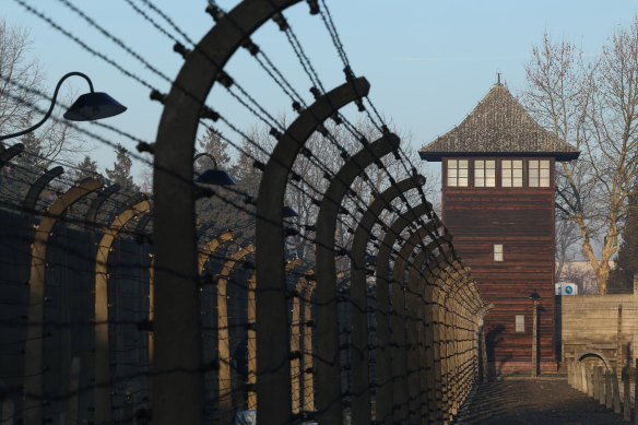 A guard tower stands among barbed wire at the Auschwitz I former concentration camp site in Oswiecim, Poland.
