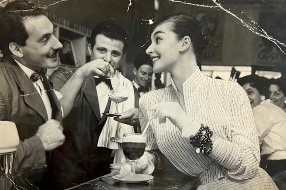 Leo (left) and Vildo Pellegrini, with an unknown woman, in the eponymous cafe they opened in Melbourne’s Bourke Street in 1954.