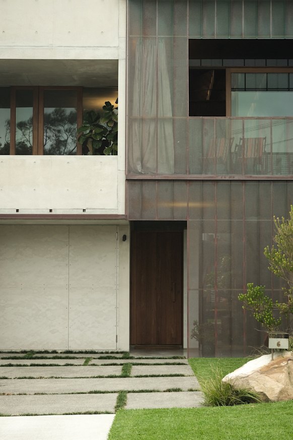 The home’s front and rear facades feature distinctive perforated copper screens that allow for both light and privacy.