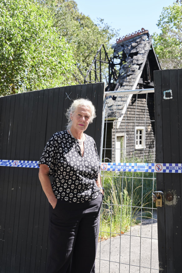 Tarni James stands in front of the charred remains of Shenley Croft, her childhood home.