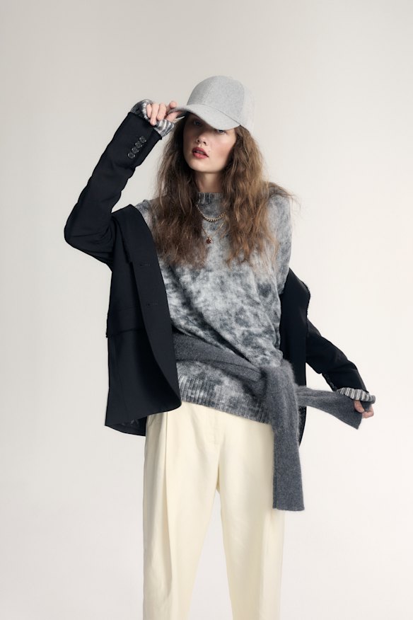Michael Kors blazer, $799. Acne Studios jumper, $510. Oroton “Pleat Slouch” pants, $429. Cable cashmere jumper (around waist), $449, and cap, $89. Temple of the Sun “Pompeii” pendant necklace, $349.